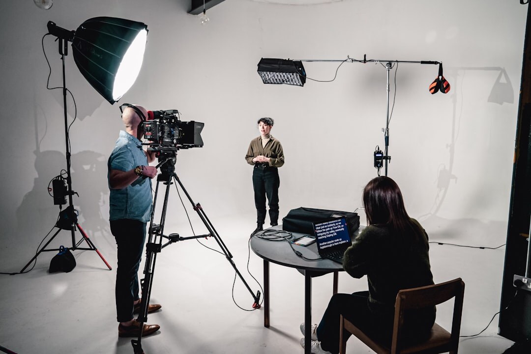 Camera operator filming in TV studio